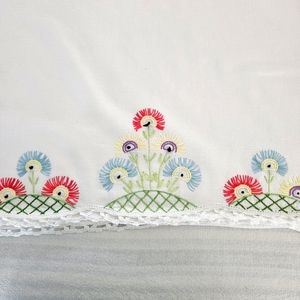 This is a pair of handmade pillowcases. 100% cotton Embroidered motif of flowers